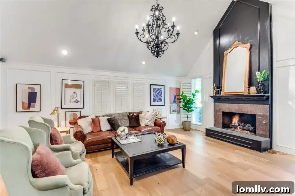 Living room with vaulted ceiling, dramatic fireplace, and modern furnishings