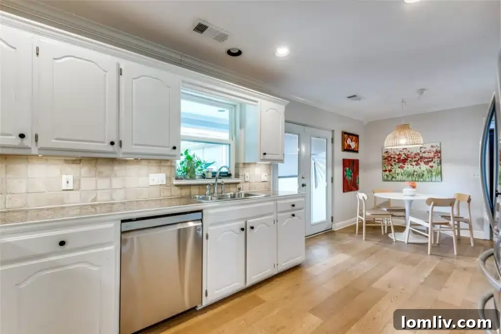 Kitchen with eat-in breakfast nook, granite countertops, and modern appliances