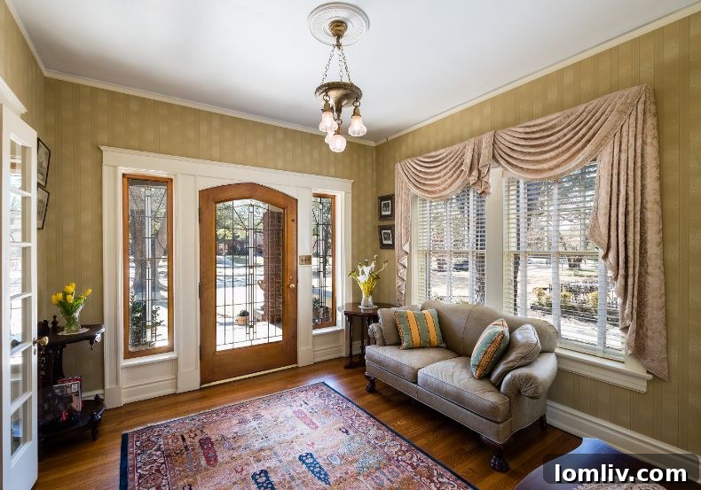 A beautifully appointed room at 6017 Swiss Avenue, showcasing intricate original woodwork, a grand fireplace, and curated decorative elements that are central to the home's cherished family traditions.