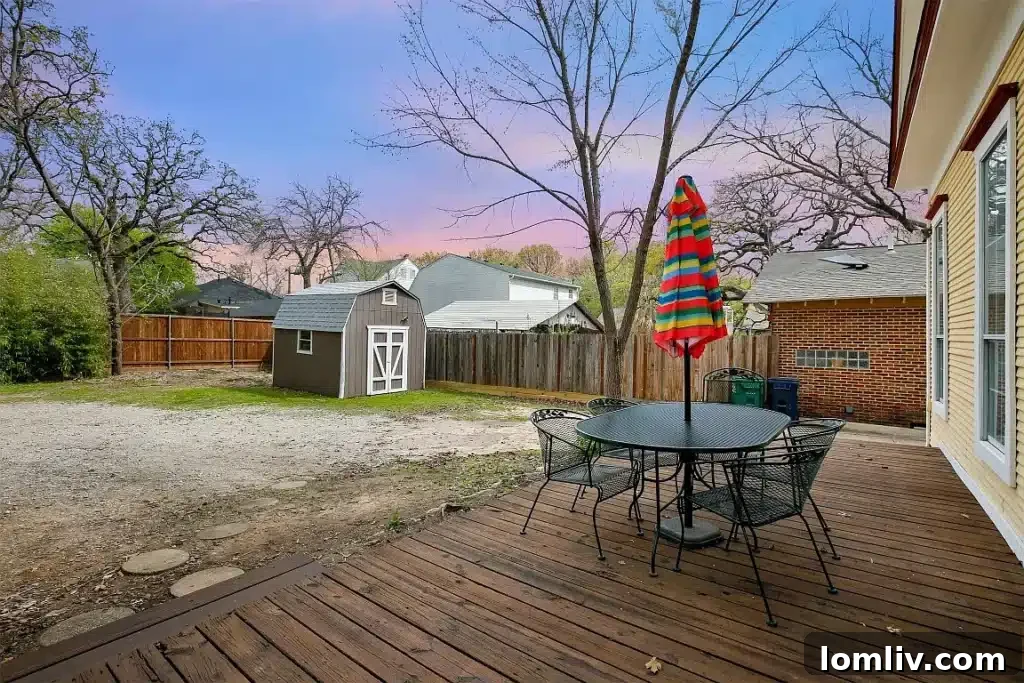 Rear exterior view of the Victorian home with a spacious backyard.