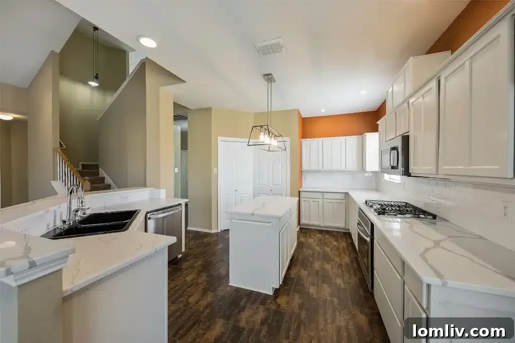 Spacious kitchen with island and dining area, ideal for family gatherings.