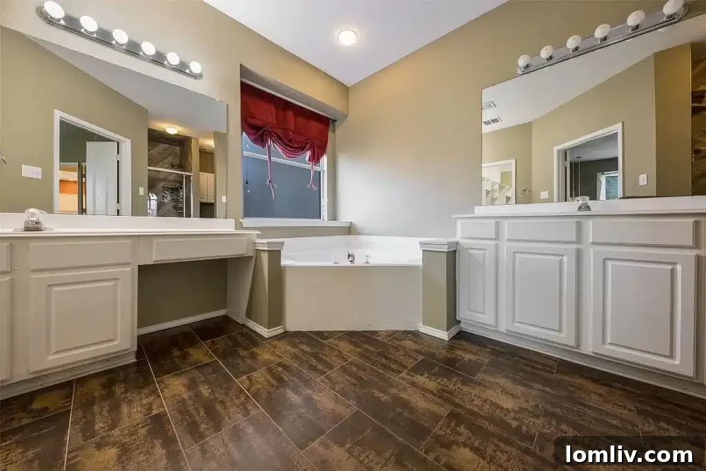 Luxurious primary bathroom with dual sinks and a large shower.