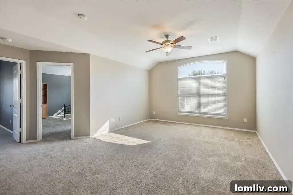 Another view of an upstairs bedroom, showcasing its spaciousness.