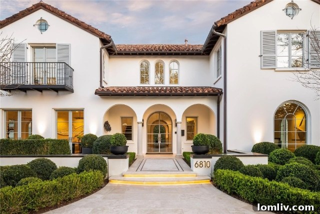 Stunning exterior view of a transformed Santa Barbara modern villa in Dallas, showcasing contemporary design elements and lush landscaping