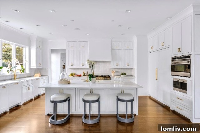 Elegant primary bathroom with dual vanities, modern fixtures, a large walk-in shower, and refined tile work