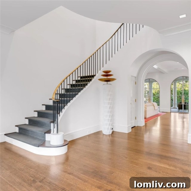 Elegant living room interior of the Santa Barbara modern villa with sleek furnishings, a contemporary fireplace, and abundant natural light