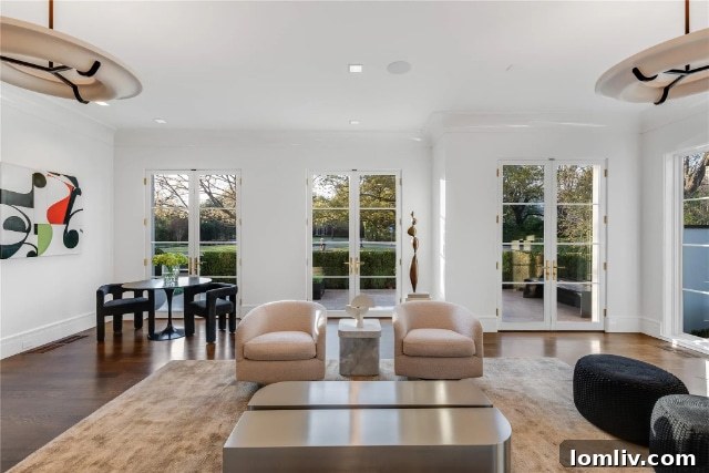 Spacious dining area with contemporary lighting, custom millwork, and expansive windows overlooking the meticulously landscaped property