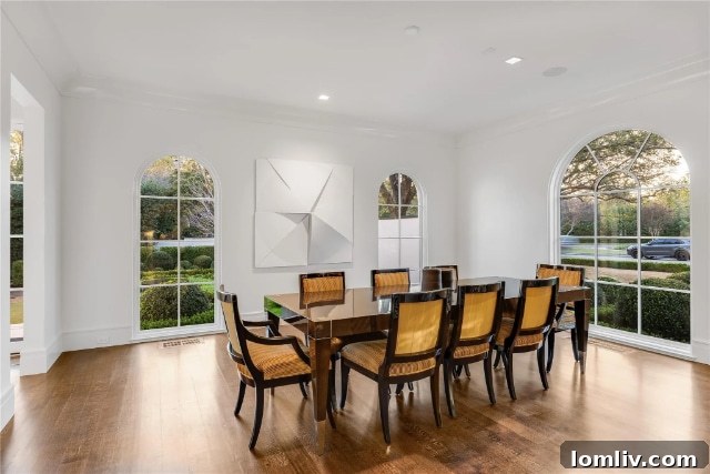 Luxurious master bathroom with a freestanding soaking tub, dual vanities, marble finishes, and contemporary fixtures