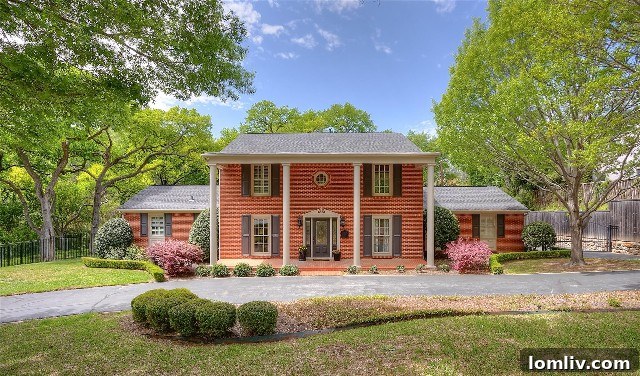 Grand Colonial home at 4132 Tamworth Road nestled in the lush Ridglea Hills neighborhood, showcasing its stately presence and beautifully landscaped surroundings.