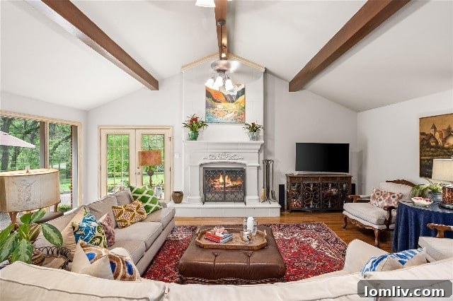Warm and spacious family room at 4132 Tamworth Road, featuring high ceilings with rustic wooden beams, a cozy fireplace, and ample seating for gathering and relaxation.