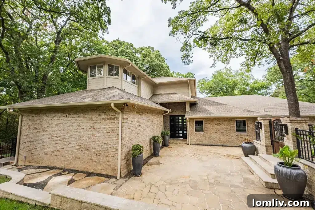 Colleyville Luxury: Homes That Redefine Grandeur 3 Exterior view of 7312 Hix Court, a modern Colleyville manor surrounded by lush greenery