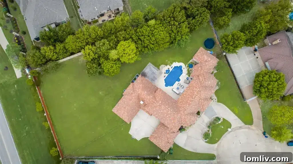 Colleyville Luxury: Homes That Redefine Grandeur 39 Overview of the serene backyard and pool area, emphasizing privacy at 3900 Saint James Court