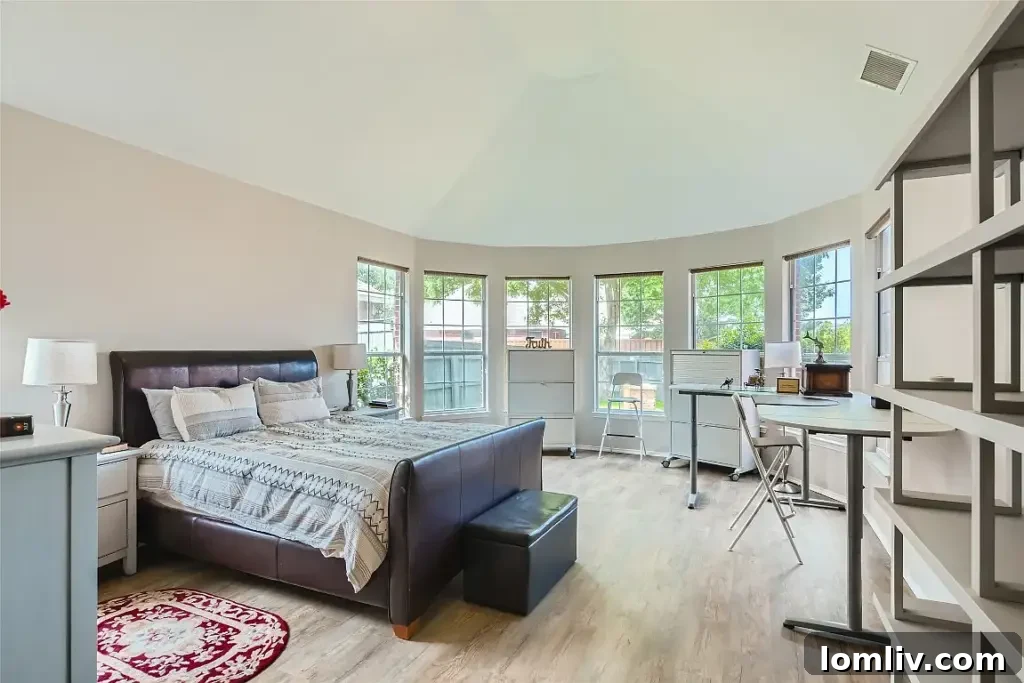 Luxurious master bathroom with a large tub and separate shower in this Rowlett home.