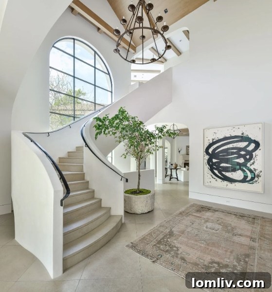 Dramatic plaster staircase in luxury Modern Spanish Revival home