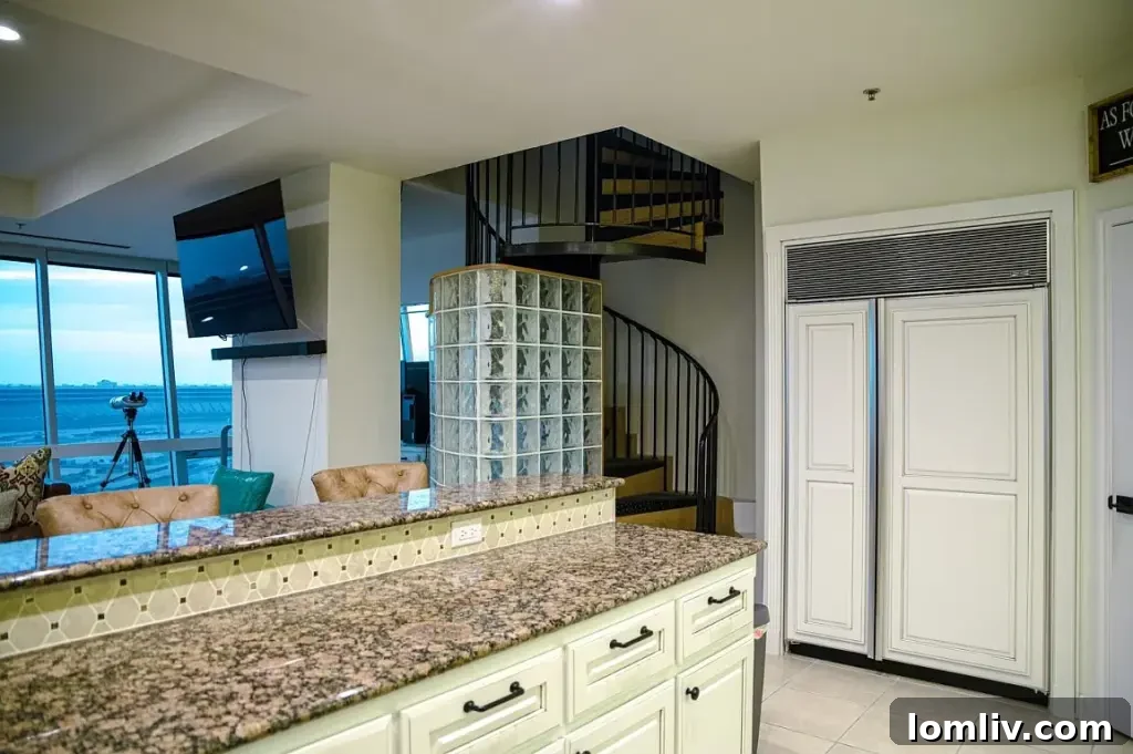 A.J. Foyt's Texas Motor Speedway Penthouse Accelerates Your Life 6 A spiral staircase leading to an upper level, showcasing modern design and elegant railing.