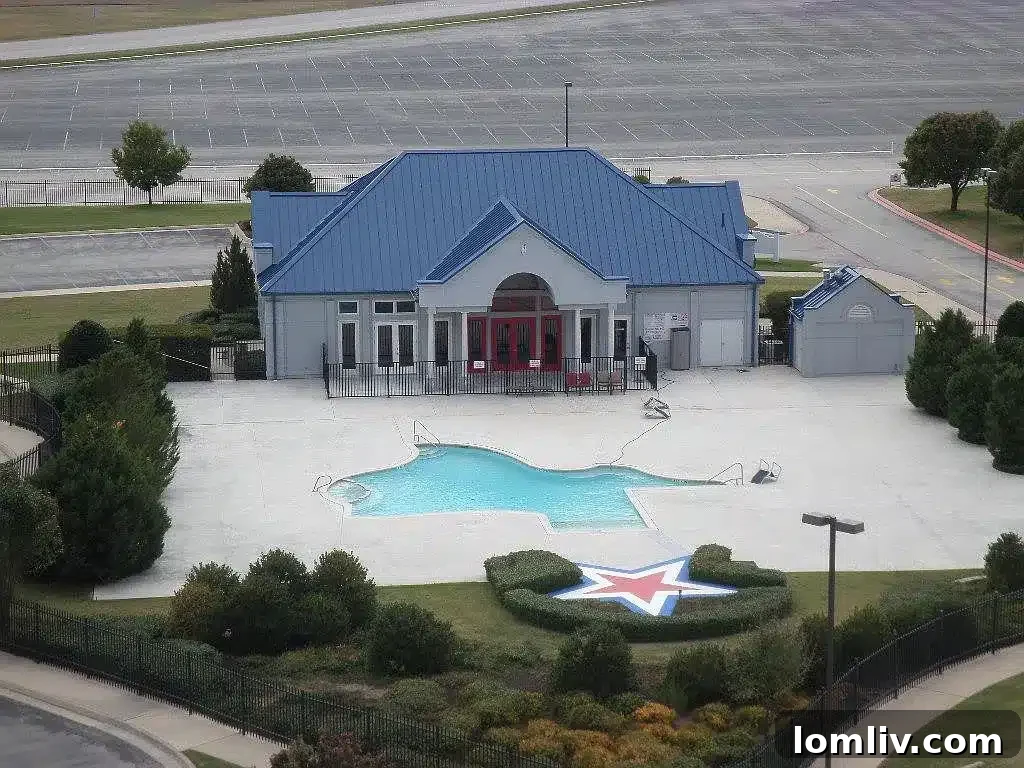 A.J. Foyt's Texas Motor Speedway Penthouse Accelerates Your Life 8 A unique swimming pool shaped like the state of Texas, surrounded by lounge chairs and greenery.