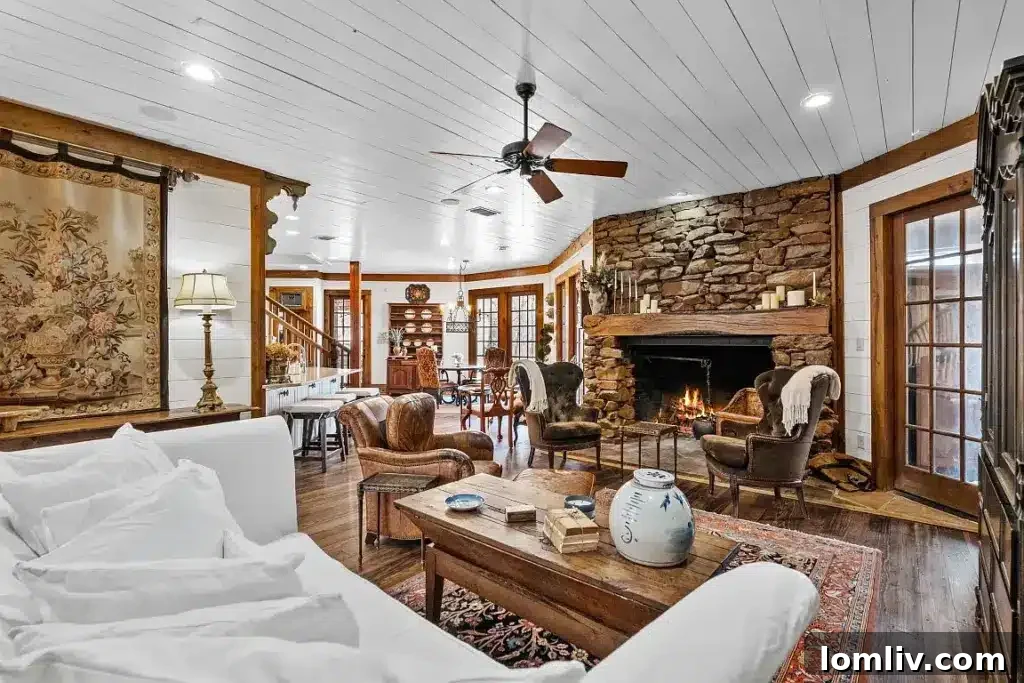 A large living room with a grand stone fireplace