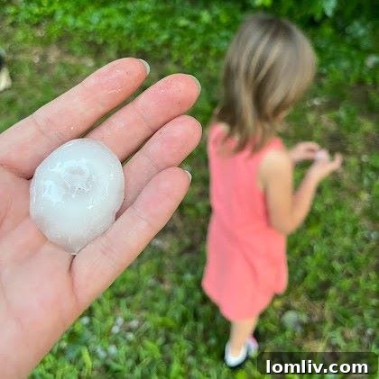 Another perspective of a hail-damaged roof, highlighting broken or displaced shingles and exposed underlayment.
