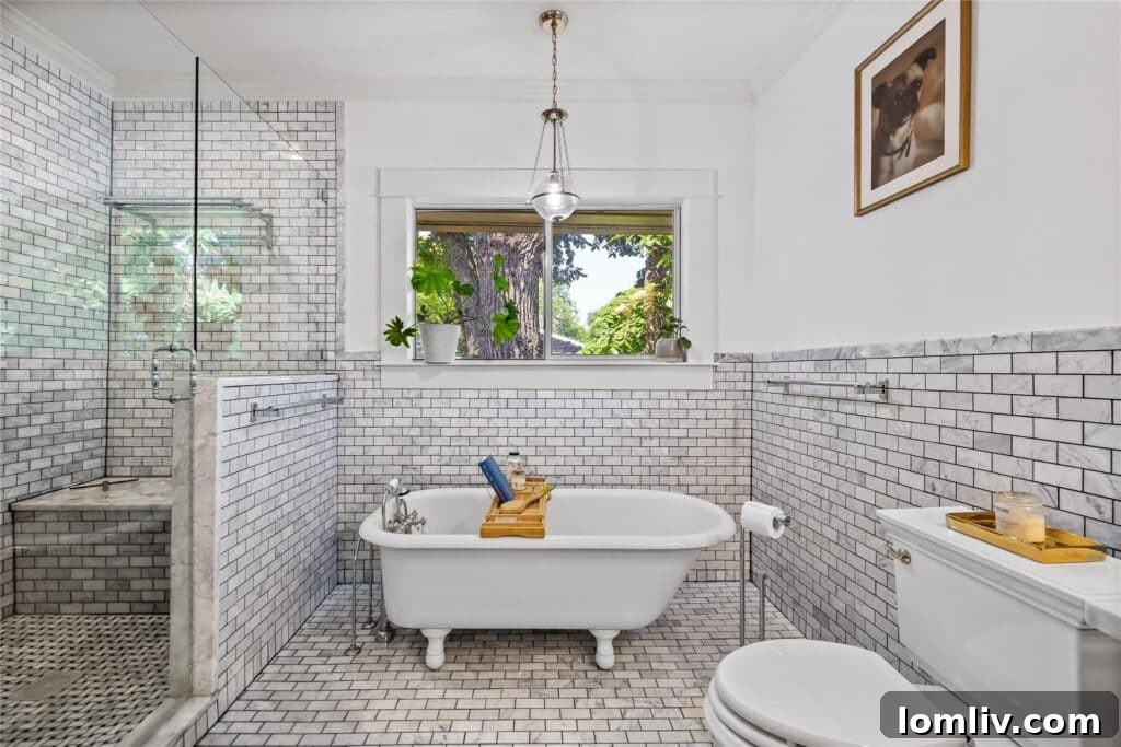 The luxurious primary bathroom featuring a classic clawfoot tub and a separate modern shower.