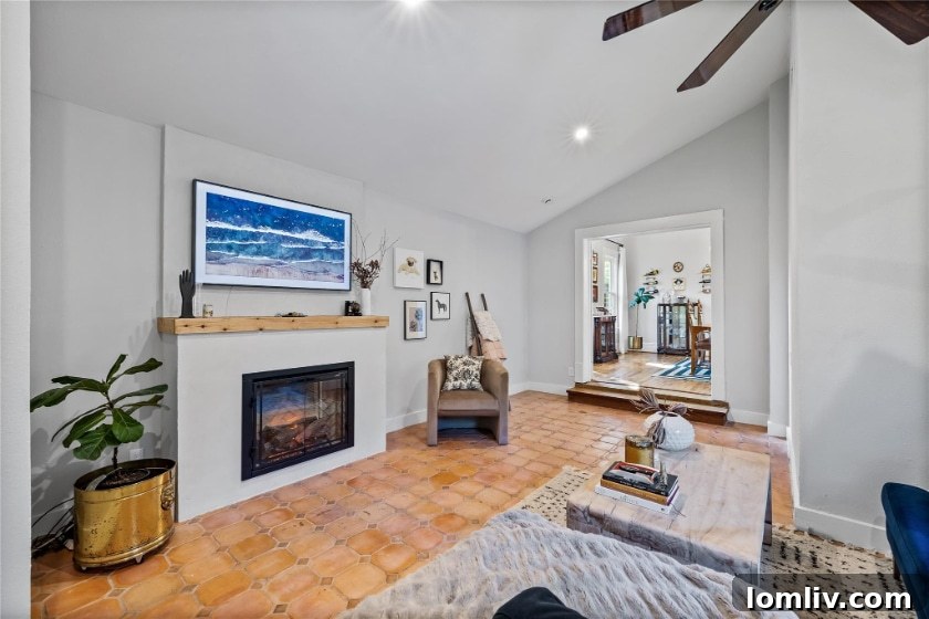 The step-down family room, likely a late-century addition, has Spanish tile floors and vaulted ceilings. 