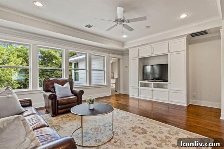 Luxurious primary bathroom featuring dual vanities, a separate tub, and a spacious shower