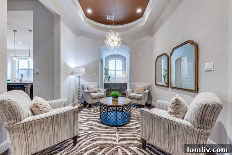 Luxurious primary bedroom featuring a separate sitting area and an elegant ensuite bathroom