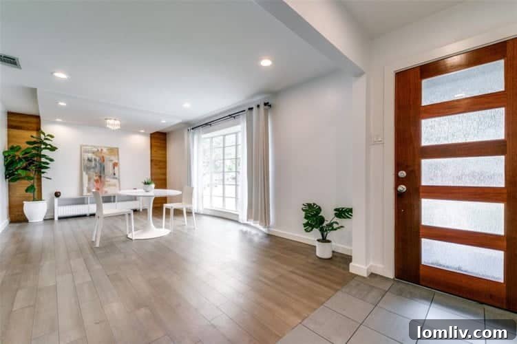 Contemporary living room with bright white walls, elegant flooring, and ample natural light