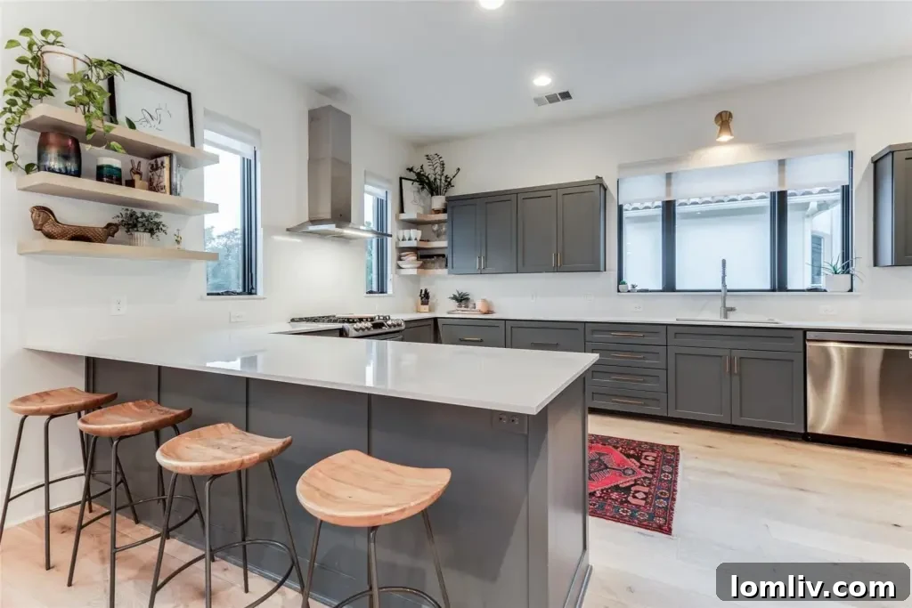 Gourmet kitchen featuring quartz countertops, stainless-steel appliances, and a connected pantry