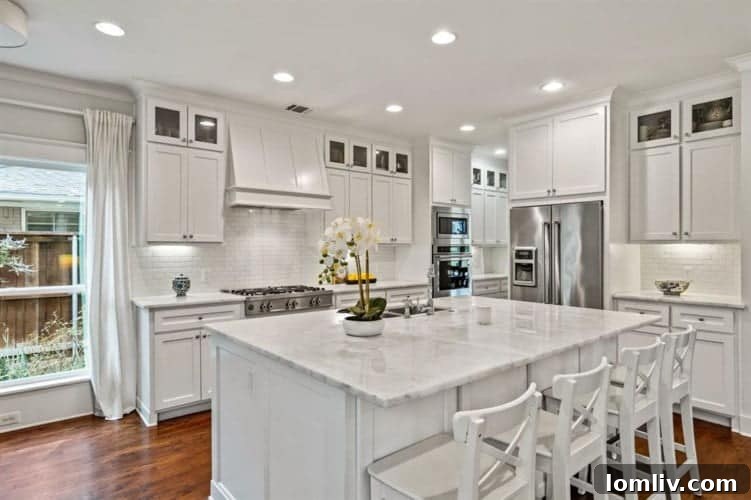 Spacious kitchen with bespoke cabinetry, high-end appliances, and large island