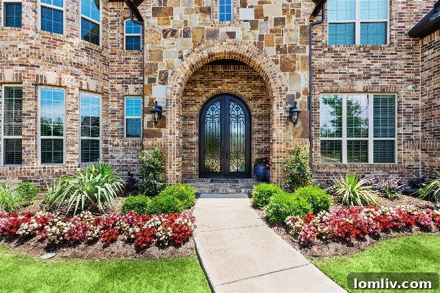 Grand double iron front doors leading into a luxurious Colleyville home
