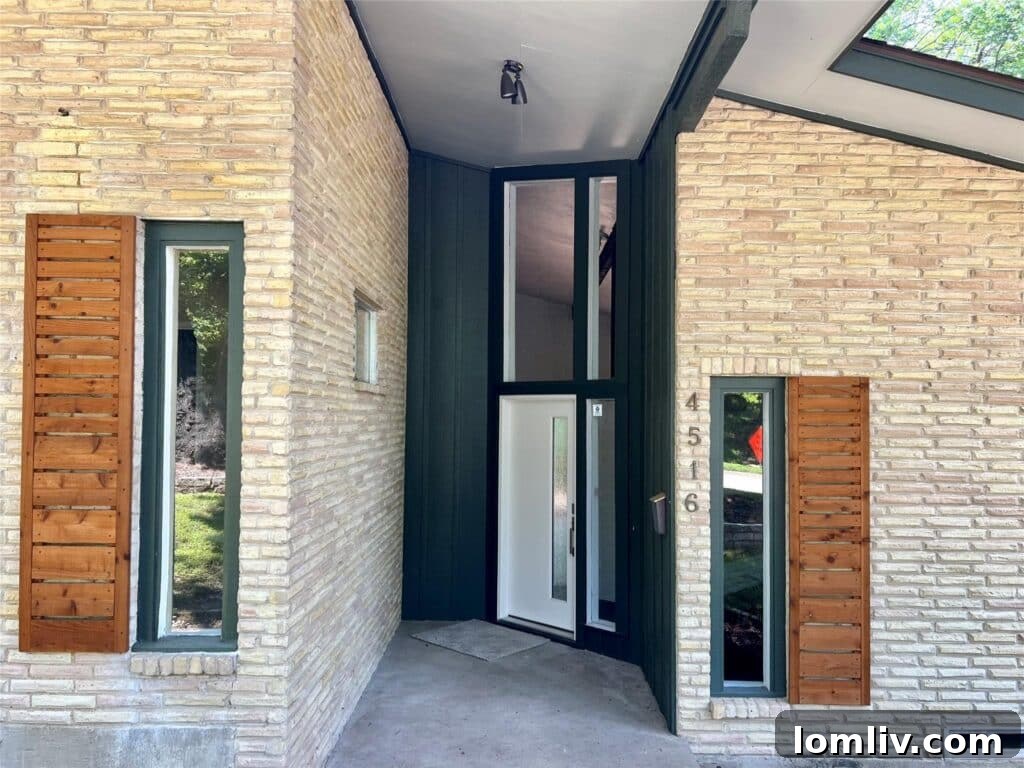 Striking roofline and entrance of an Oak Cliff Midcentury Modern residence