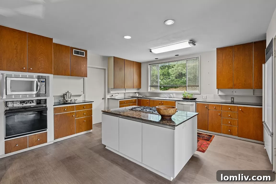 An original Midcentury Modern kitchen in Fort Worth, featuring well-maintained cabinetry and appliances.