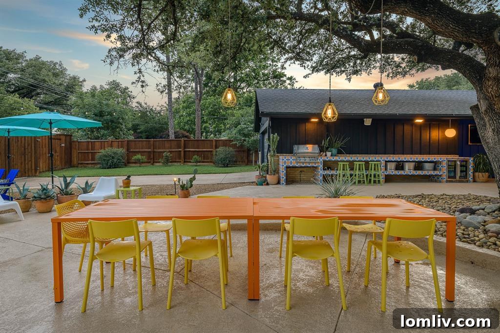 The stylish outdoor dining area next to the pool, featuring modern furniture and lush greenery.