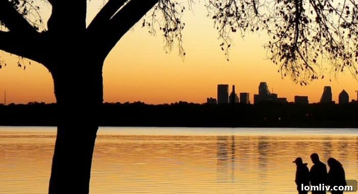 Scenic view of White Rock Lake Park in Dallas at sunset, reflecting trees and sky on the water.