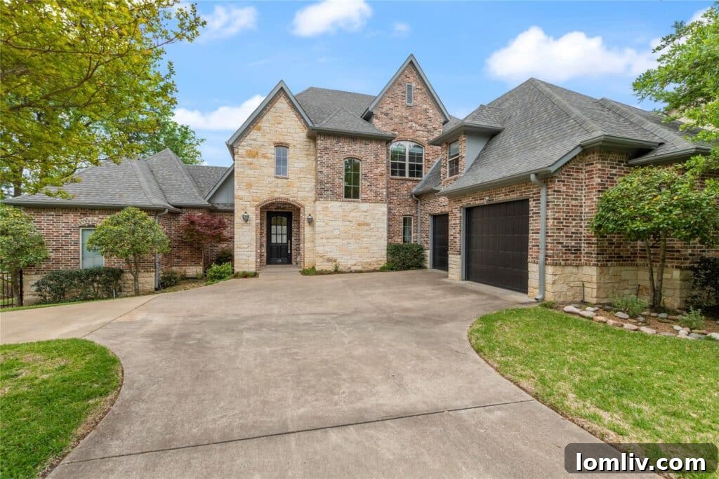Charming lake house with a stone exterior and large windows overlooking the water.