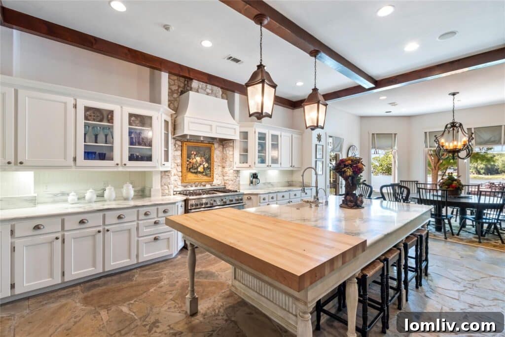 Spacious gourmet kitchen with a large marble island and professional-grade appliances.