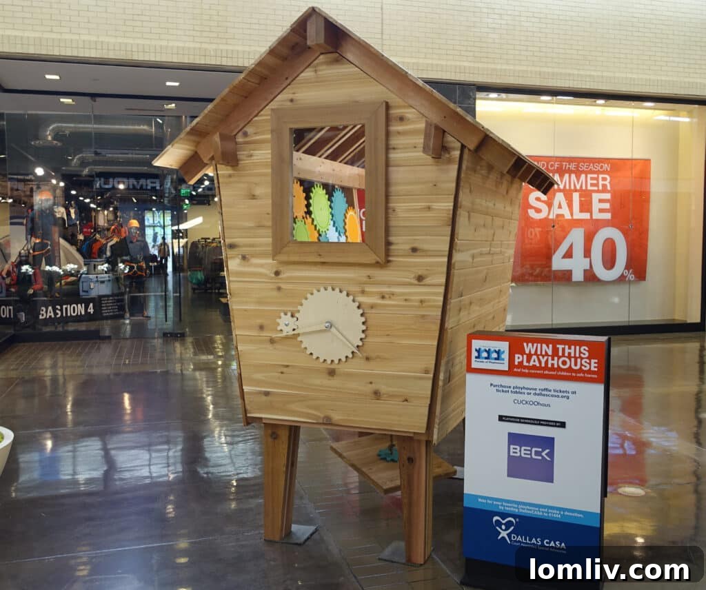 A vibrant, multi-colored playhouse resembling a cuckoo clock or abstract art, featuring geometric shapes and bright primary and secondary colors.