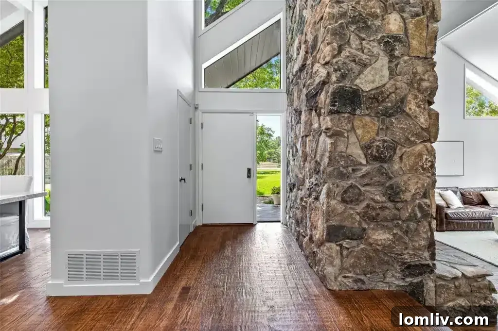 Spacious Living Area with Stone Fireplace and High Ceilings