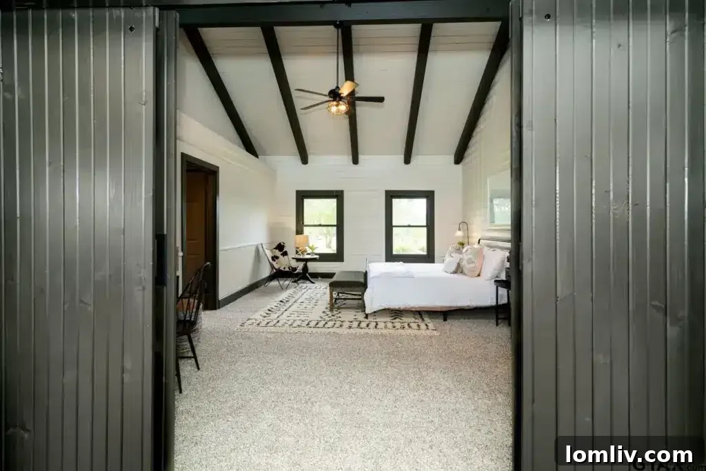 Primary bedroom suite with plush carpeting and access to a private outdoor space