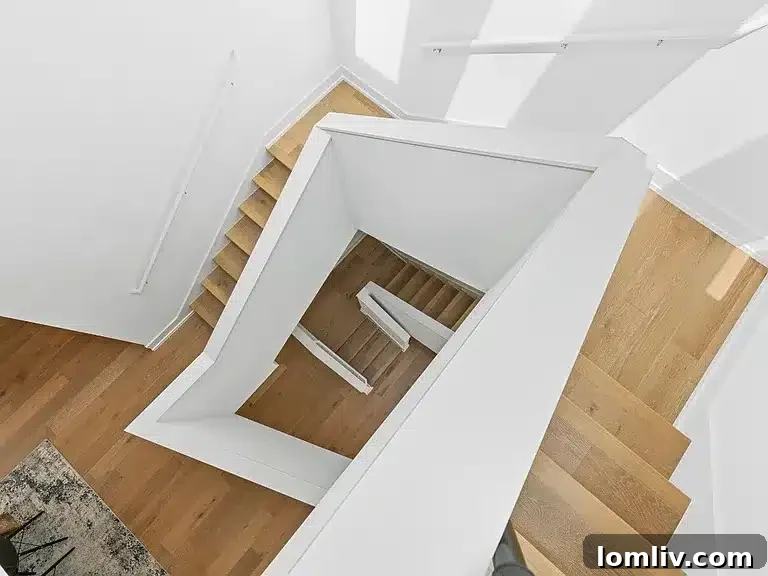 View of the contemporary living area with a part of the floating staircase visible.