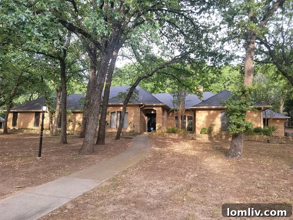 A Keller home surrounded by towering trees in both front and back yards.