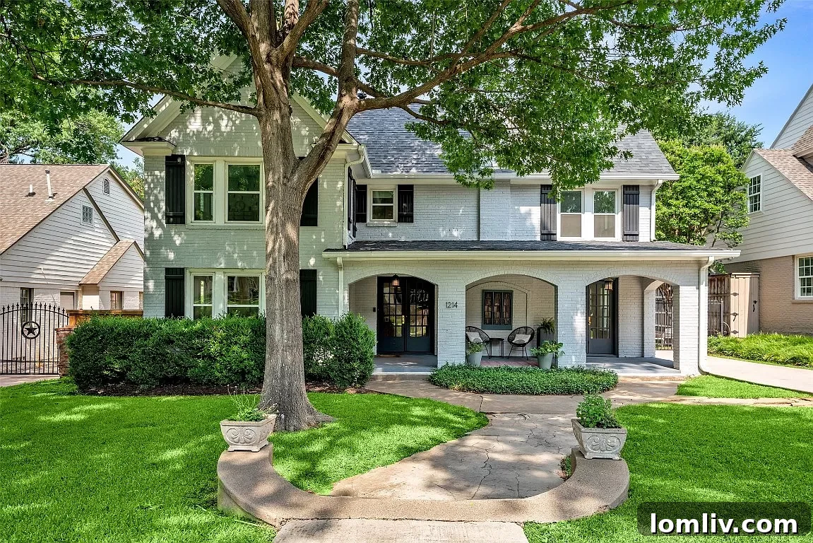 A charming Kessler Park home with a large, mature tree providing ample shade over its front yard.