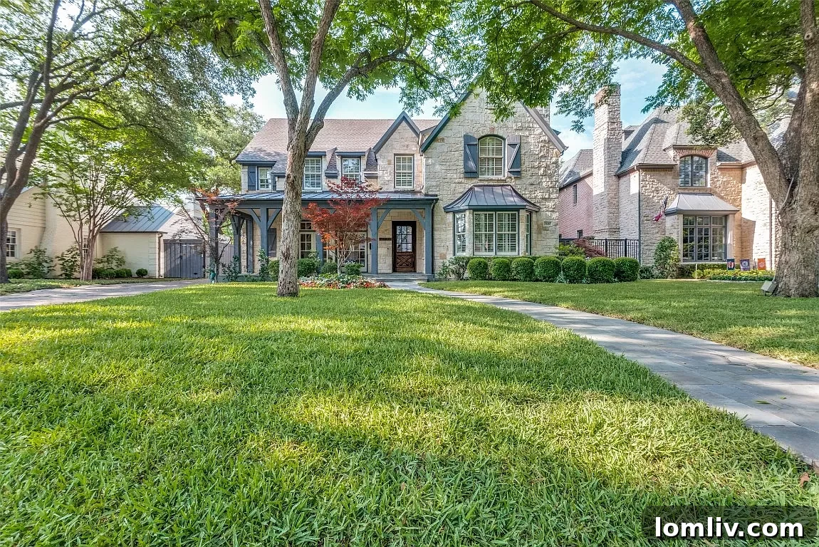 A grand University Park home with majestic trees framing its elegant facade.