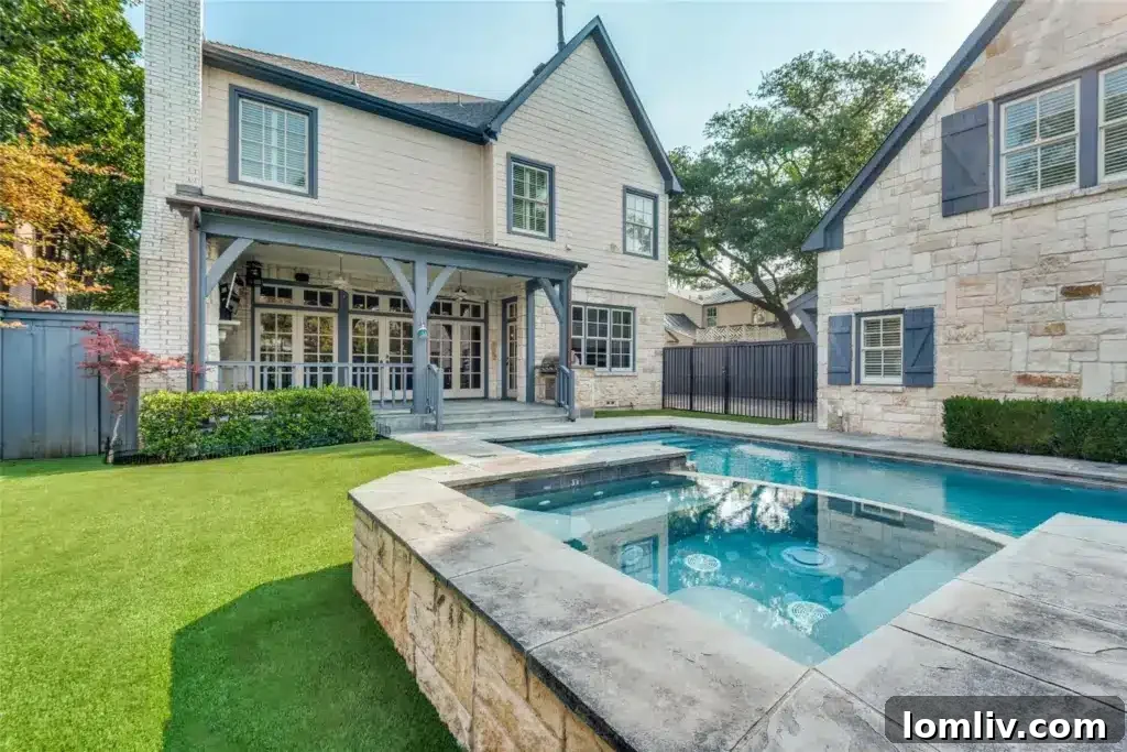 A beautiful backyard with a covered patio and a sparkling pool.