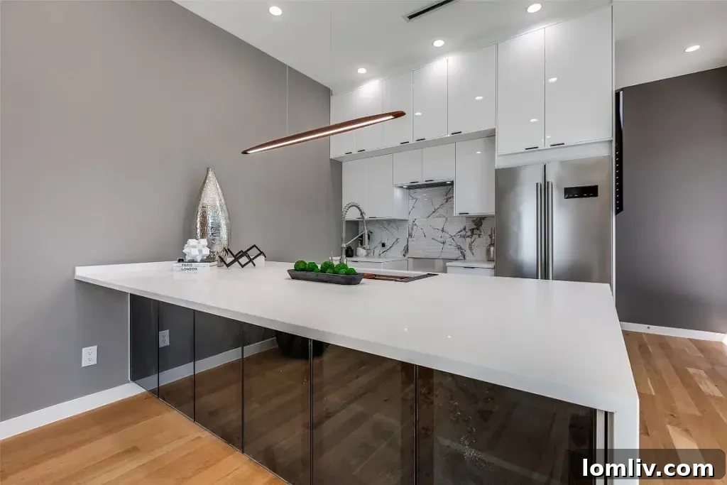 Gourmet kitchen featuring an oversized waterfall island and professional appliances at 2724 Hondo Ave