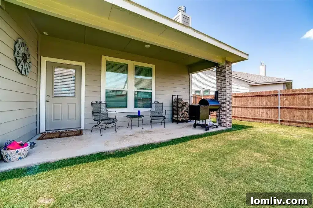 Go West to Springtown: Live the Country Dream on a Budget 14 A vast, green backyard with a covered patio, an expansive lawn, and plenty of open space, ideal for outdoor activities and entertaining.