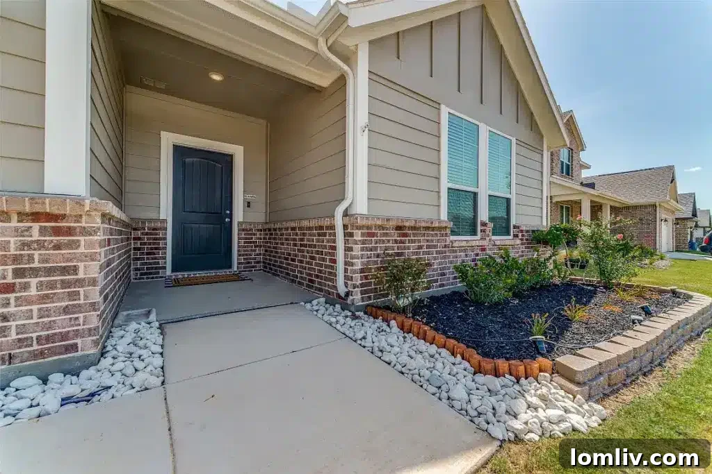 Go West to Springtown: Live the Country Dream on a Budget 3 The exterior front view of a newly built Texas home, featuring a harmonious blend of brick and siding, a welcoming porch, and well-maintained landscaping.