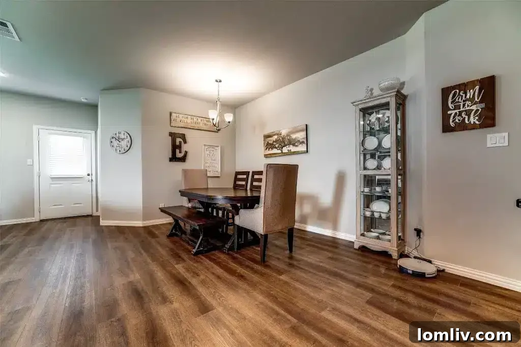 Go West to Springtown: Live the Country Dream on a Budget 6 A contemporary dining area featuring a wooden table and chairs, set within an open-plan living space with views into the kitchen.
