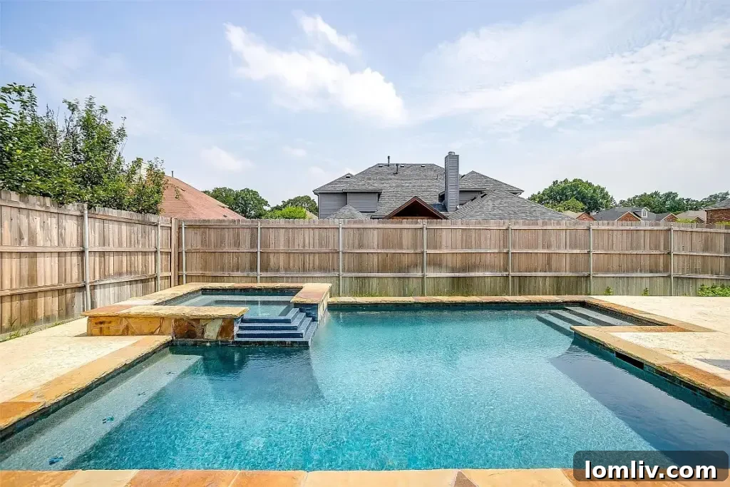Stunning backyard oasis with a sparkling pool, waterfall, and spa at 1505 Chateau Lane