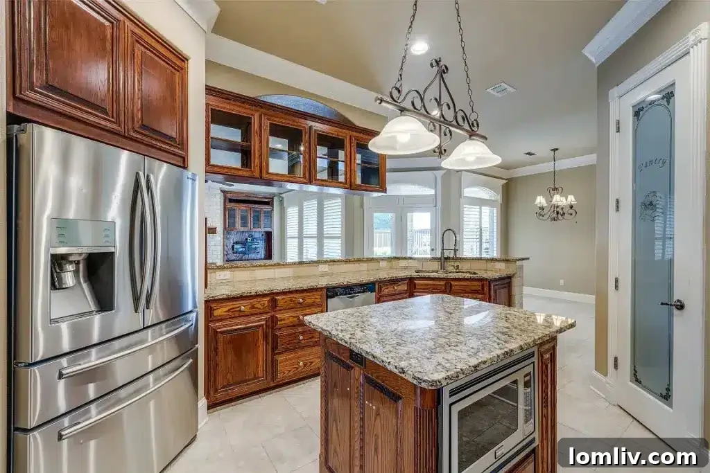 Gourmet kitchen with custom cabinetry and island at 1305 Danbury Drive